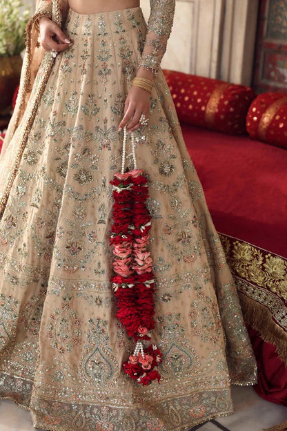 A graceful net outfit featuring hand-embellished panels, blouse, and sleeves, paired with an embroidered organza dupatta for a luxurious formal look.