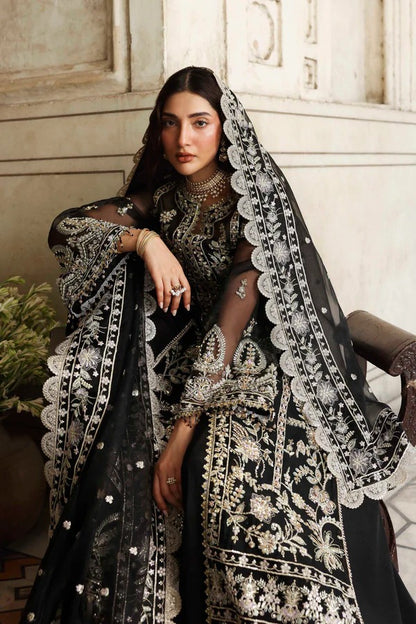 Elegant organza outfit with hand-embellished panels, sleeves, and borders, paired with a matching dupatta and raw silk trouser for a refined formal look.