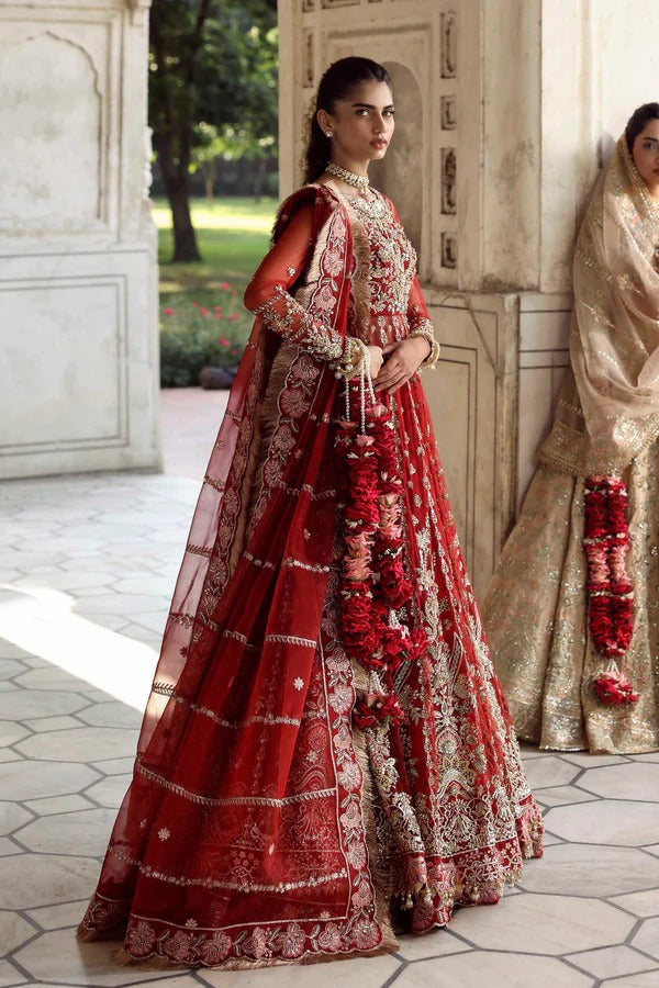 This stunning net outfit features hand-embellished panels, embroidered sleeves, and an organza dupatta with lehenga border—perfect for formal festive wear.