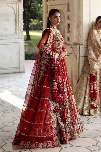 This stunning net outfit features hand-embellished panels, embroidered sleeves, and an organza dupatta with lehenga border—perfect for formal festive wear.