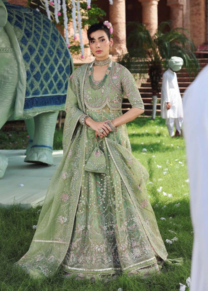 Elevate your festive look with this sage green zari organza outfit featuring delicate hand embroidery, printed raw silk trousers, and an elegant dupatta.