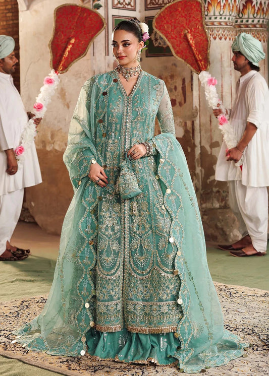 Discover timeless elegance with this turquoise organza outfit featuring intricate hand embroidery, foil-printed raw silk trouser, and embroidered dupatta.