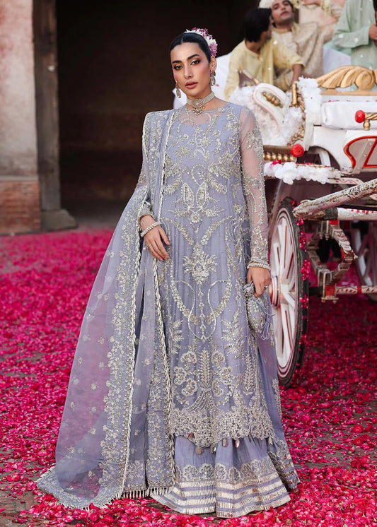 Grace your occasions with this periwinkle organza ensemble featuring hand-embroidered panels, borders, and dupatta, paired with a raw silk trouser for elegance.