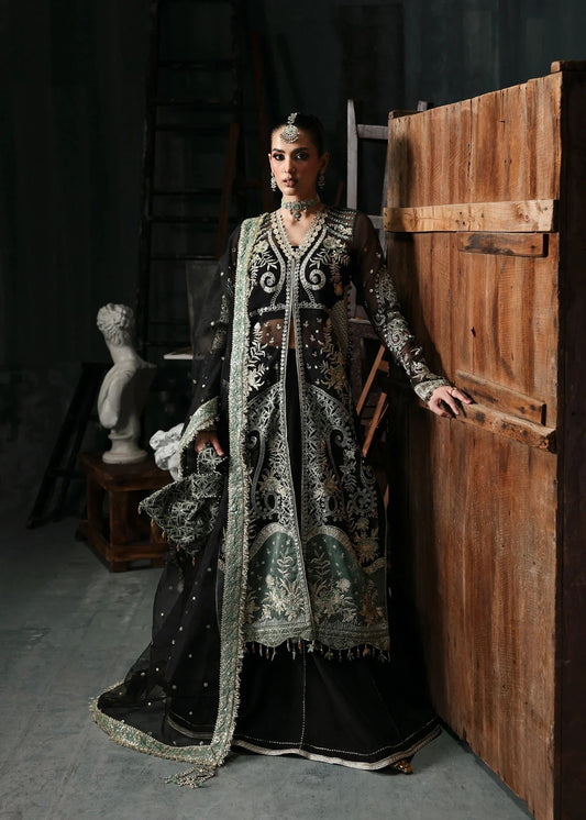 Elegant black organza dress with embroidered cutwork panels, dupatta & raw silk trouser. Available stitched or unstitched with custom sizing options.