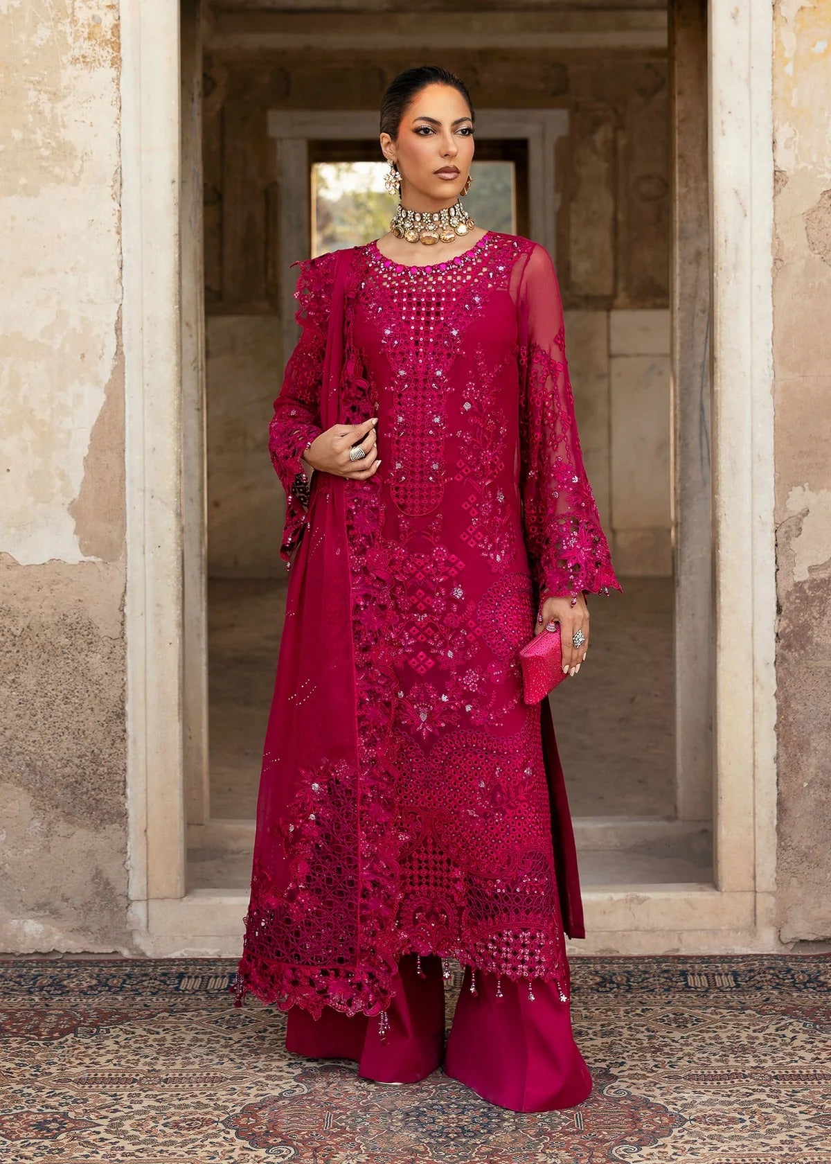 Elegant chiffon suit with hand-embellished neckline, cutwork borders, diamante dupatta with organza motifs, and raw silk trouser — ideal for festive wear.