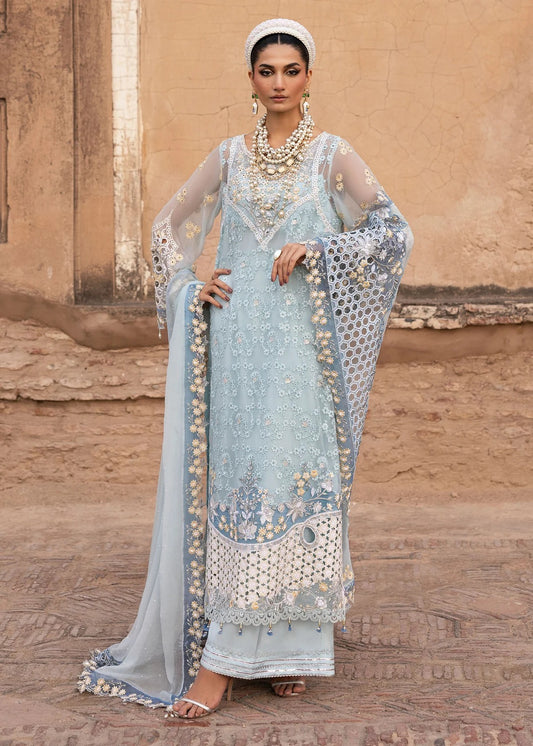 Luxury chiffon suit with hand-embellished neckline, 3D floral sleeve motifs, cutwork borders, diamante dupatta, and raw silk trouser — perfect for occasions.