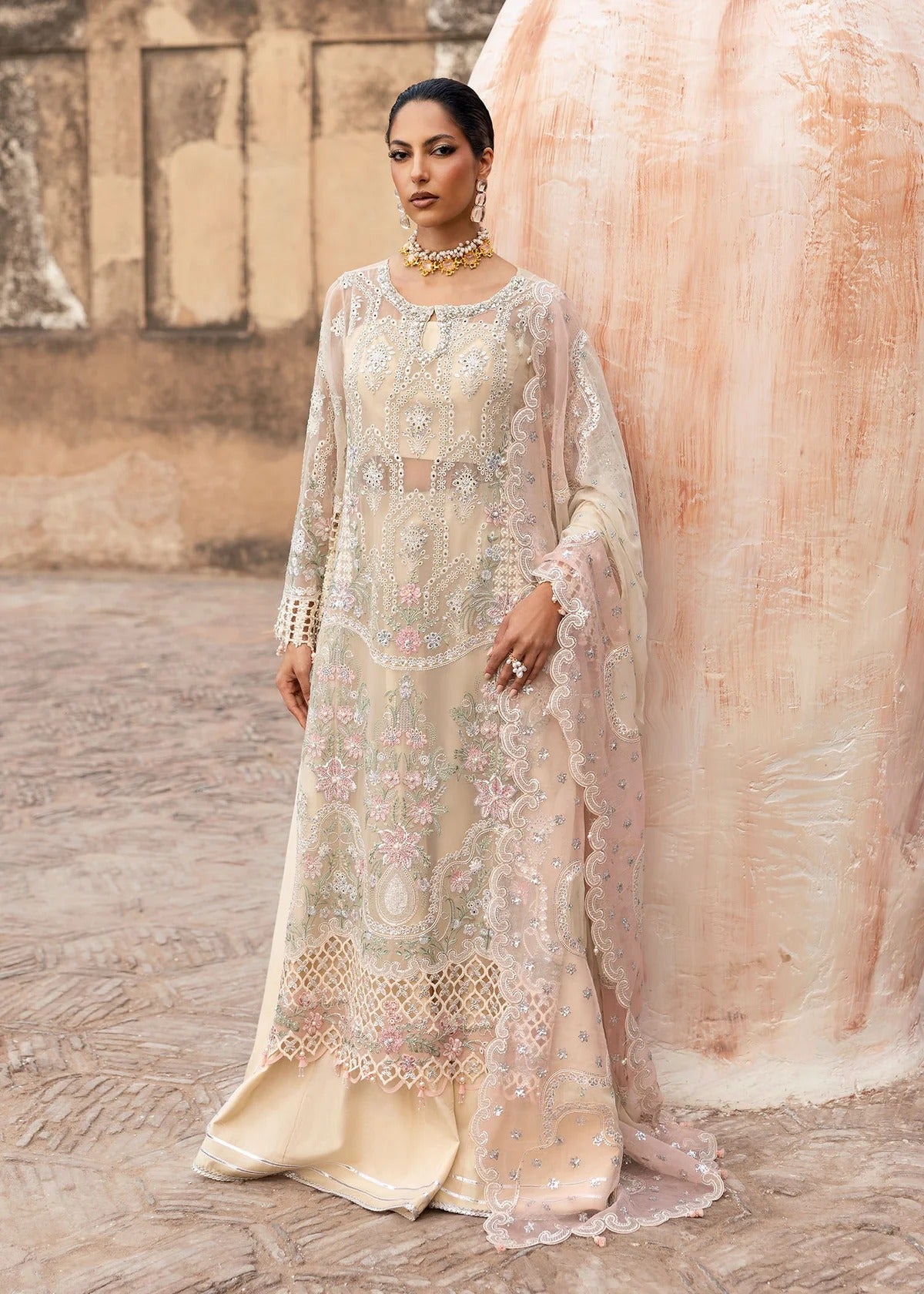 Elegant chiffon embroidered suit with hand embellishment, cutwork borders, diamante & mukesh dupatta, and raw silk trouser perfect for festive wear.