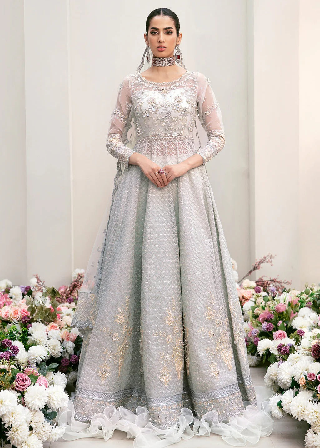Elegant organza embroidered suit with hand-embellished bodice, cutwork panels, detailed borders, dupatta, and premium raw silk trouser fabric.