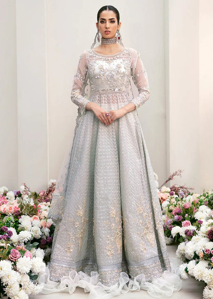 Elegant organza embroidered suit with hand-embellished bodice, cutwork panels, detailed borders, dupatta, and premium raw silk trouser fabric.