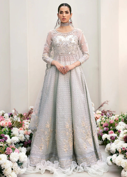Elegant organza embroidered suit with hand-embellished bodice, cutwork panels, detailed borders, dupatta, and premium raw silk trouser fabric.