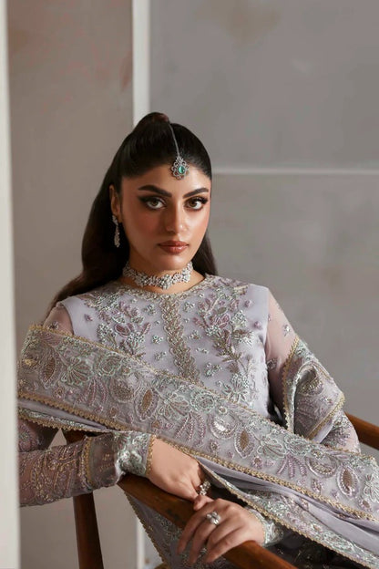 Graceful chiffon outfit with embroidered front, back, and sleeves enhanced by organza borders. Paired with a chiffon dupatta and raw silk trouser for elegance.