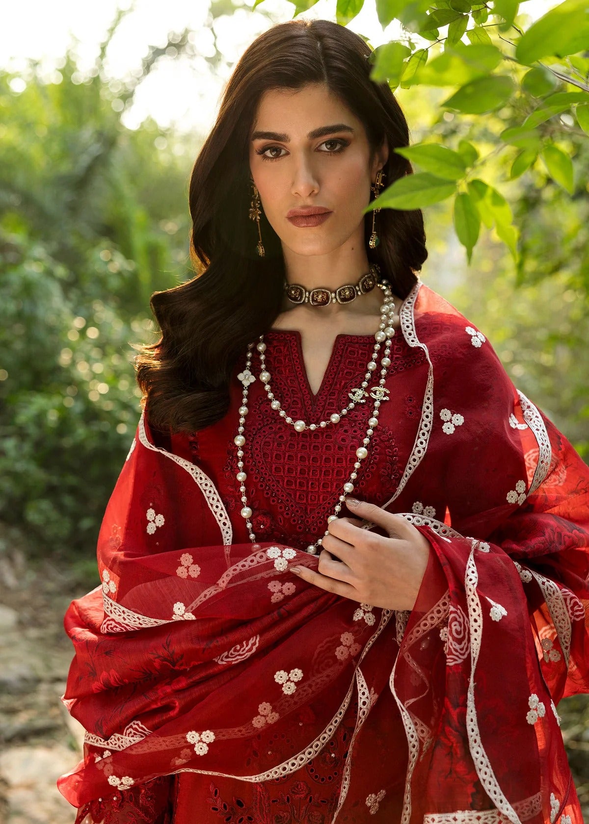 Stun in this maroon embroidered lawn suit with hand-work neckline, chikan-kari panels, 3D flowers, monar dupatta, and cotton trouser.