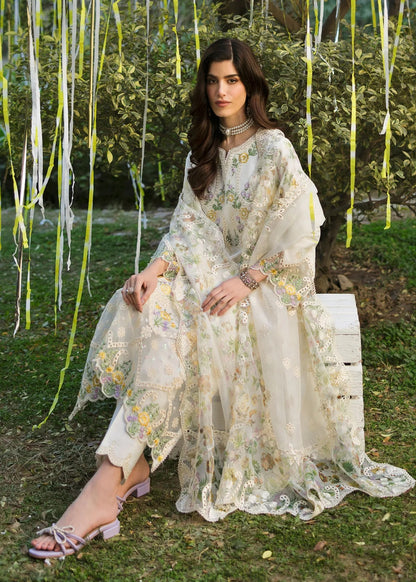 Look elegant in this ivory embroidered lawn suit with chikan-kari panels, hand-work neckline, woven net dupatta, and cotton trouser for a timeless style.