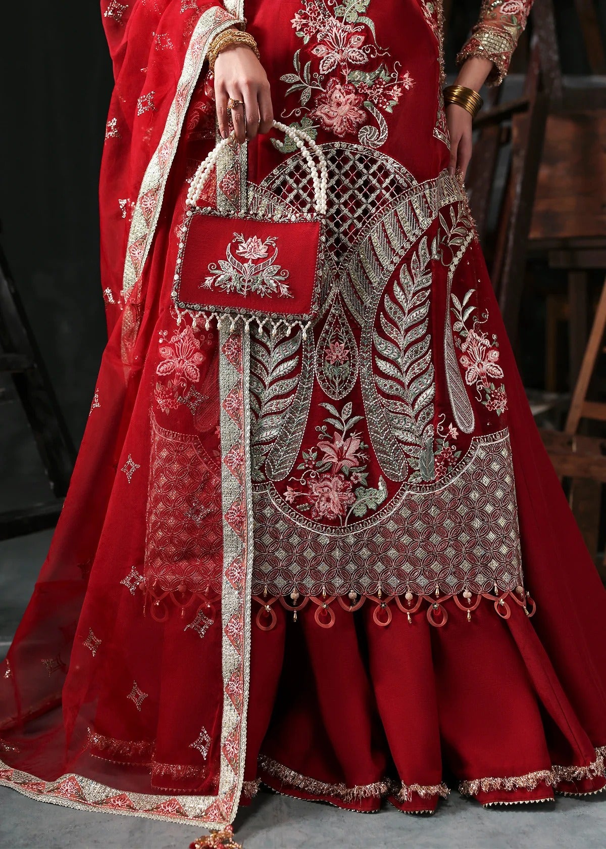 Stunning red organza dress with cutwork neckline, embroidered panels, dupatta & raw silk trouser. Available stitched/unstitch with custom sizing.