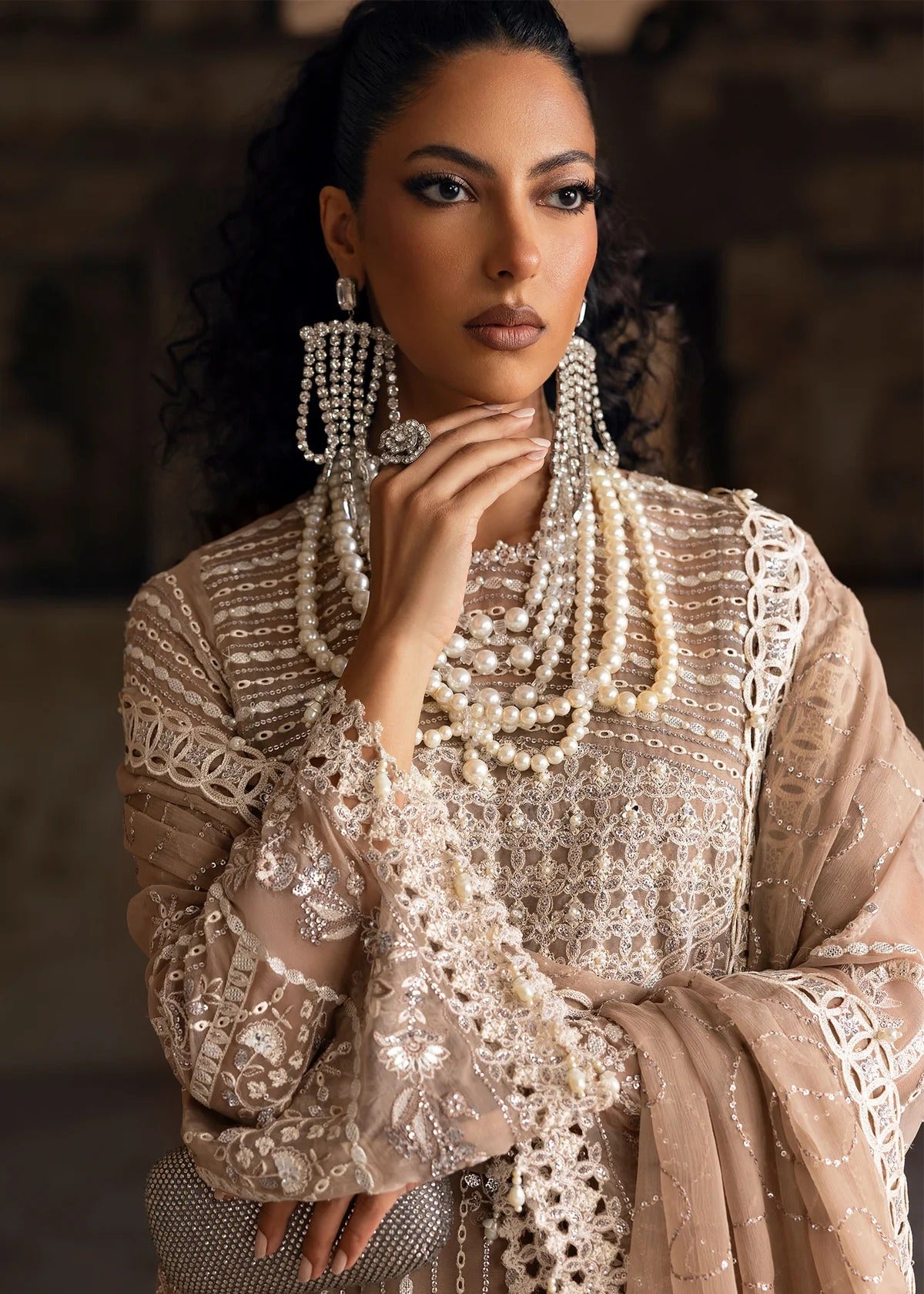 Exquisite chiffon suit with luxury hand embellishment, cutwork organza borders, embroidered dupatta, and raw silk trouser — ideal for weddings & parties.