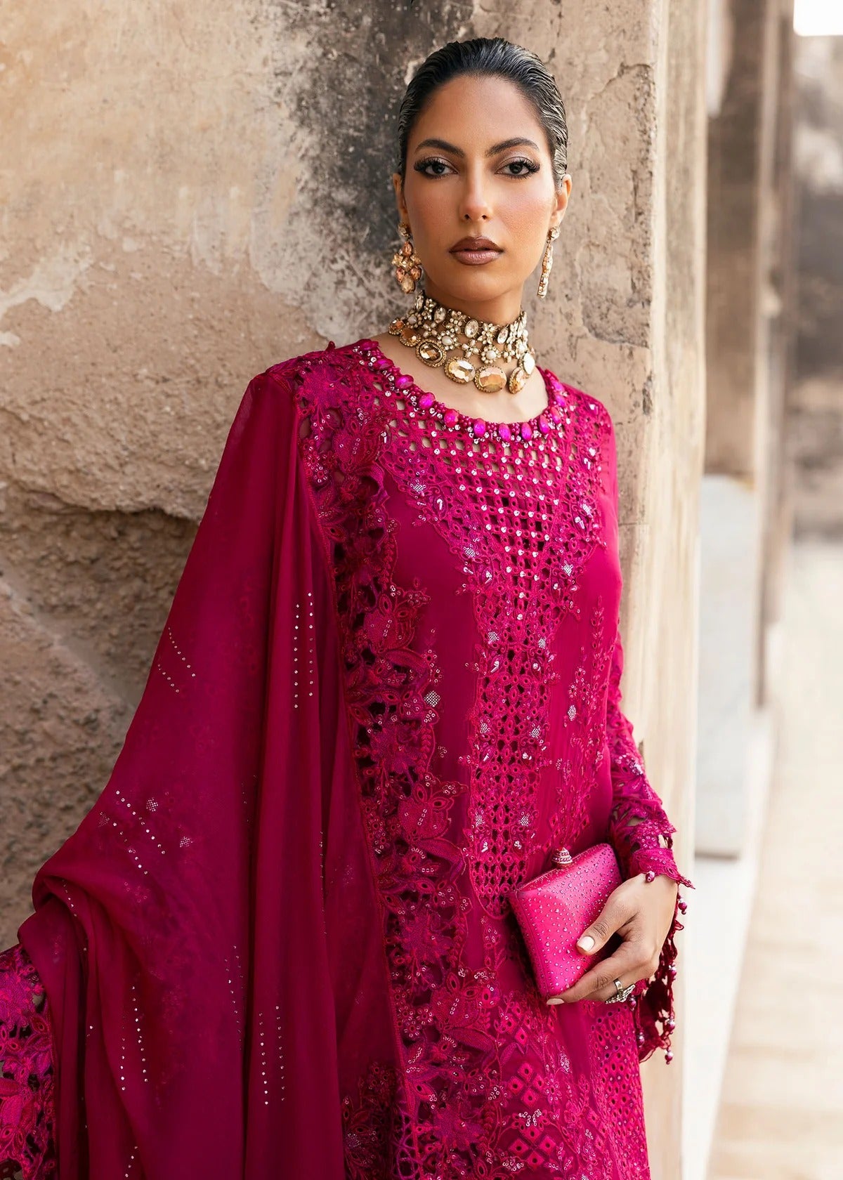 Elegant chiffon suit with hand-embellished neckline, cutwork borders, diamante dupatta with organza motifs, and raw silk trouser — ideal for festive wear.