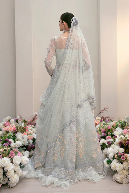 Elegant organza embroidered suit with hand-embellished bodice, cutwork panels, detailed borders, dupatta, and premium raw silk trouser fabric.