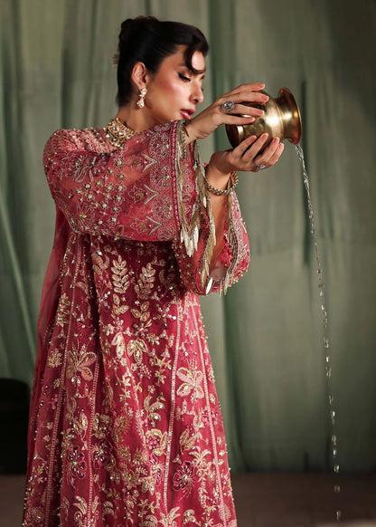 Step into elegance with this carrot pink organza ensemble featuring intricate hand embroidery, pure zari dupatta, and raw silk trouser for a refined look.