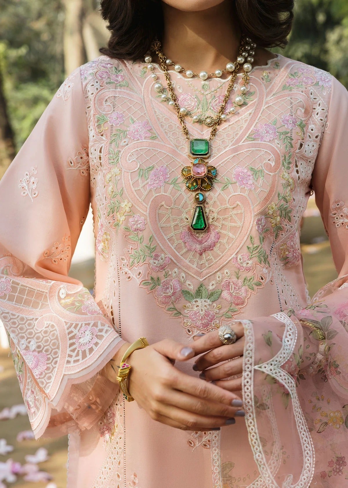 Grace your look with this peach embroidered lawn suit featuring chikan-kari panels, hand-work neckline, net dupatta, and cotton trouser.
