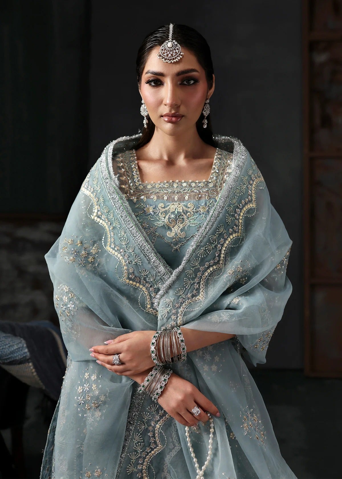 Chic ice blue organza dress with embroidered panels, dupatta & raw silk trouser. Available stitched/unstitch with custom sizing & worldwide delivery.