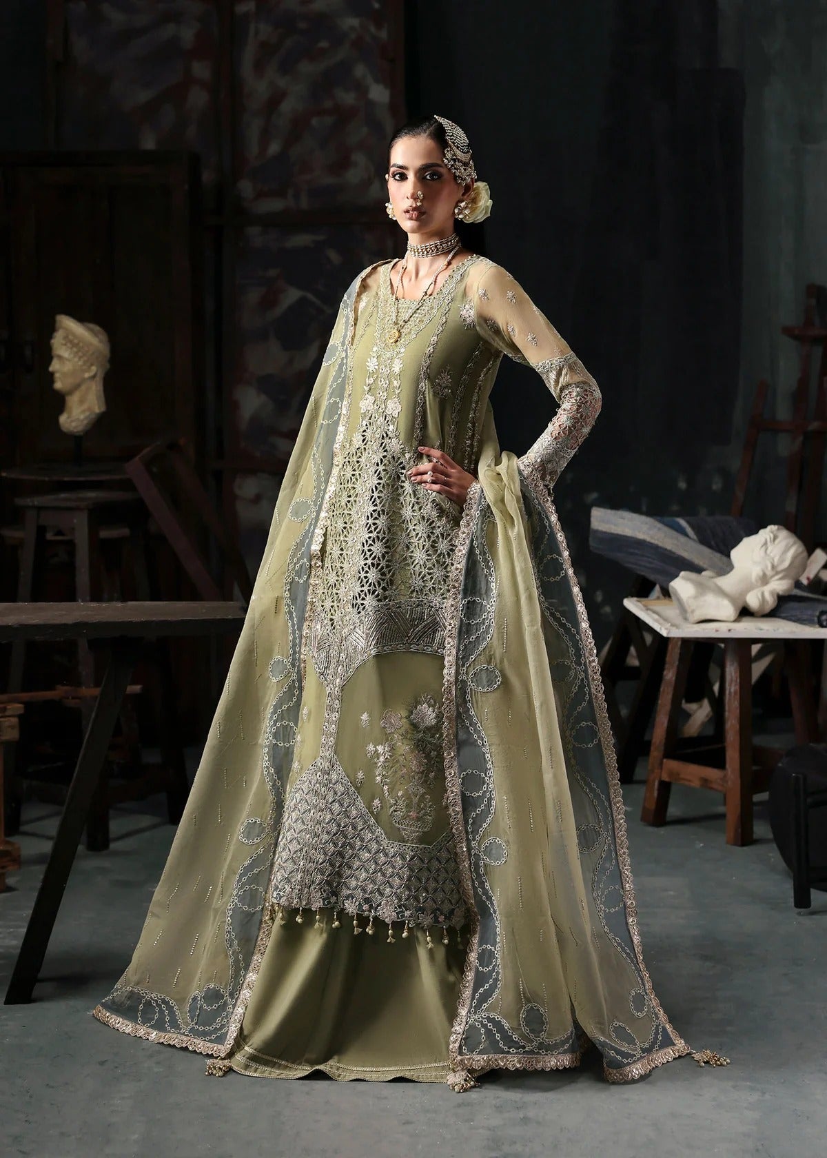 Graceful olive green organza suit with dori work, cutwork neckline, embroidered dupatta, and raw silk trouser a perfect choice for festive elegance.
