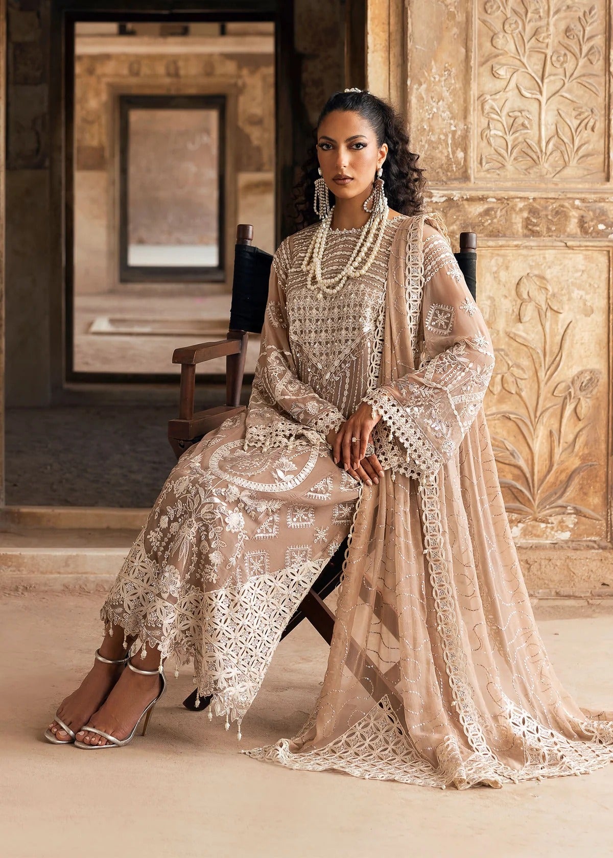 Exquisite chiffon suit with luxury hand embellishment, cutwork organza borders, embroidered dupatta, and raw silk trouser — ideal for weddings & parties.