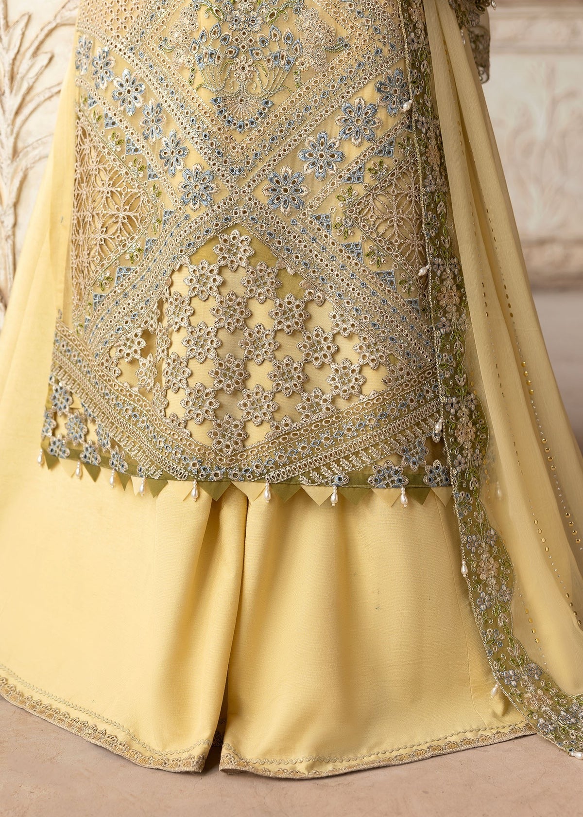 Graceful chiffon suit featuring luxury hand embellishment, cutwork organza borders, diamante & mukesh dupatta, paired with raw silk trouser.