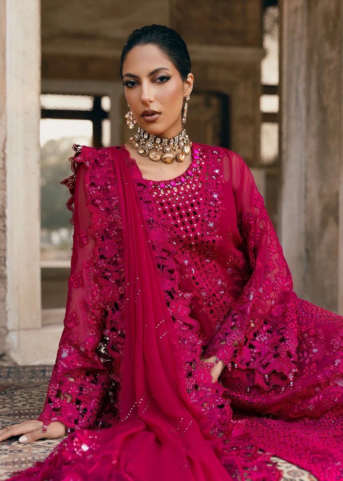 Elegant chiffon suit with hand-embellished neckline, cutwork borders, diamante dupatta with organza motifs, and raw silk trouser — ideal for festive wear.
