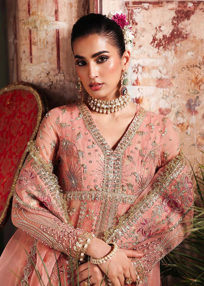 Radiate elegance in this peach organza outfit featuring intricate hand embroidery, foil printed raw silk trouser, and a beautifully embroidered dupatta.