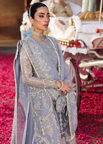 Grace your occasions with this periwinkle organza ensemble featuring hand-embroidered panels, borders, and dupatta, paired with a raw silk trouser for elegance.