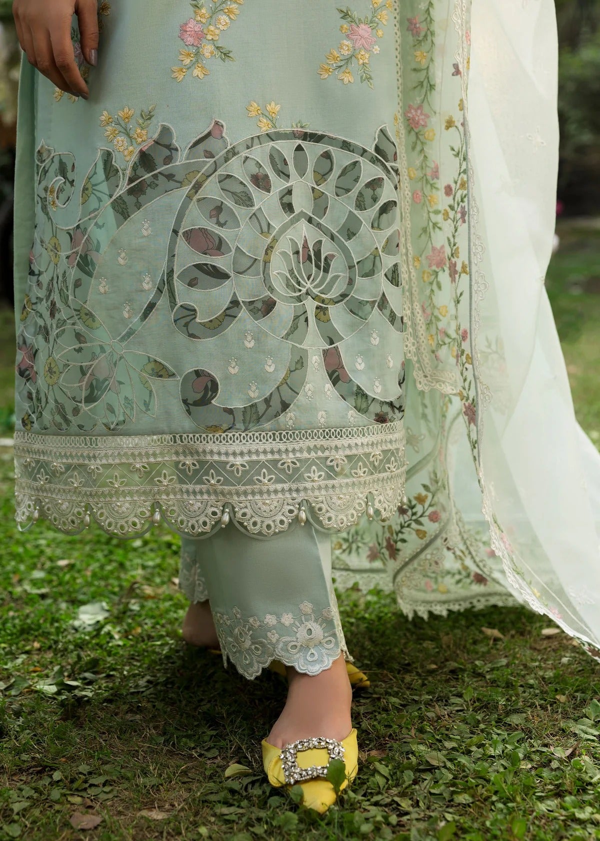Elevate your style with this sky blue embroidered lawn suit featuring hand-work neckline, chikan-kari sleeves, net dupatta, and cotton trouser.