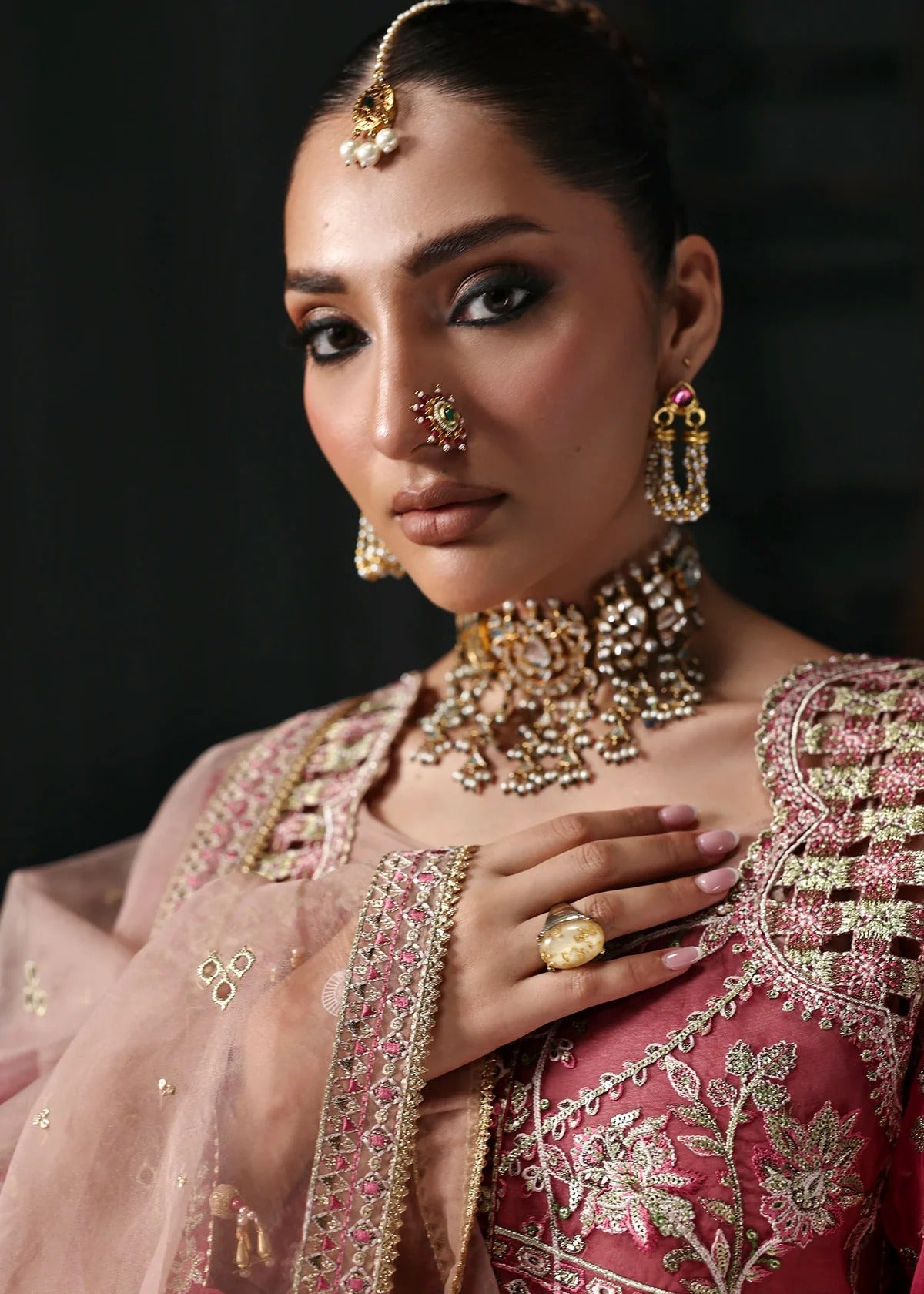 Chic rose pink organza suit with applique panels, cutwork neckline, embroidered dupatta, raw silk trouser, and elegant borders for a timeless festive look.