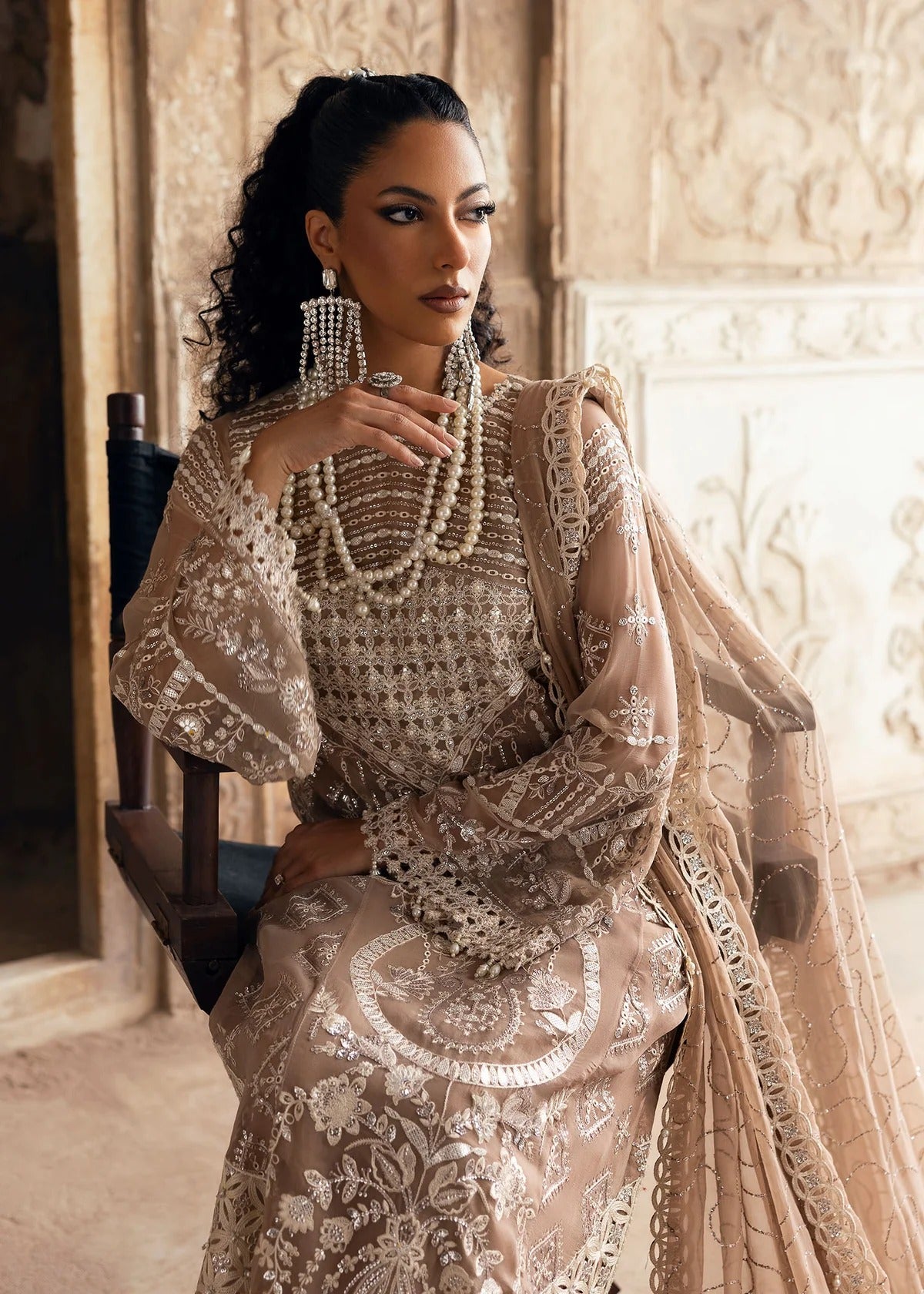 Exquisite chiffon suit with luxury hand embellishment, cutwork organza borders, embroidered dupatta, and raw silk trouser — ideal for weddings & parties.