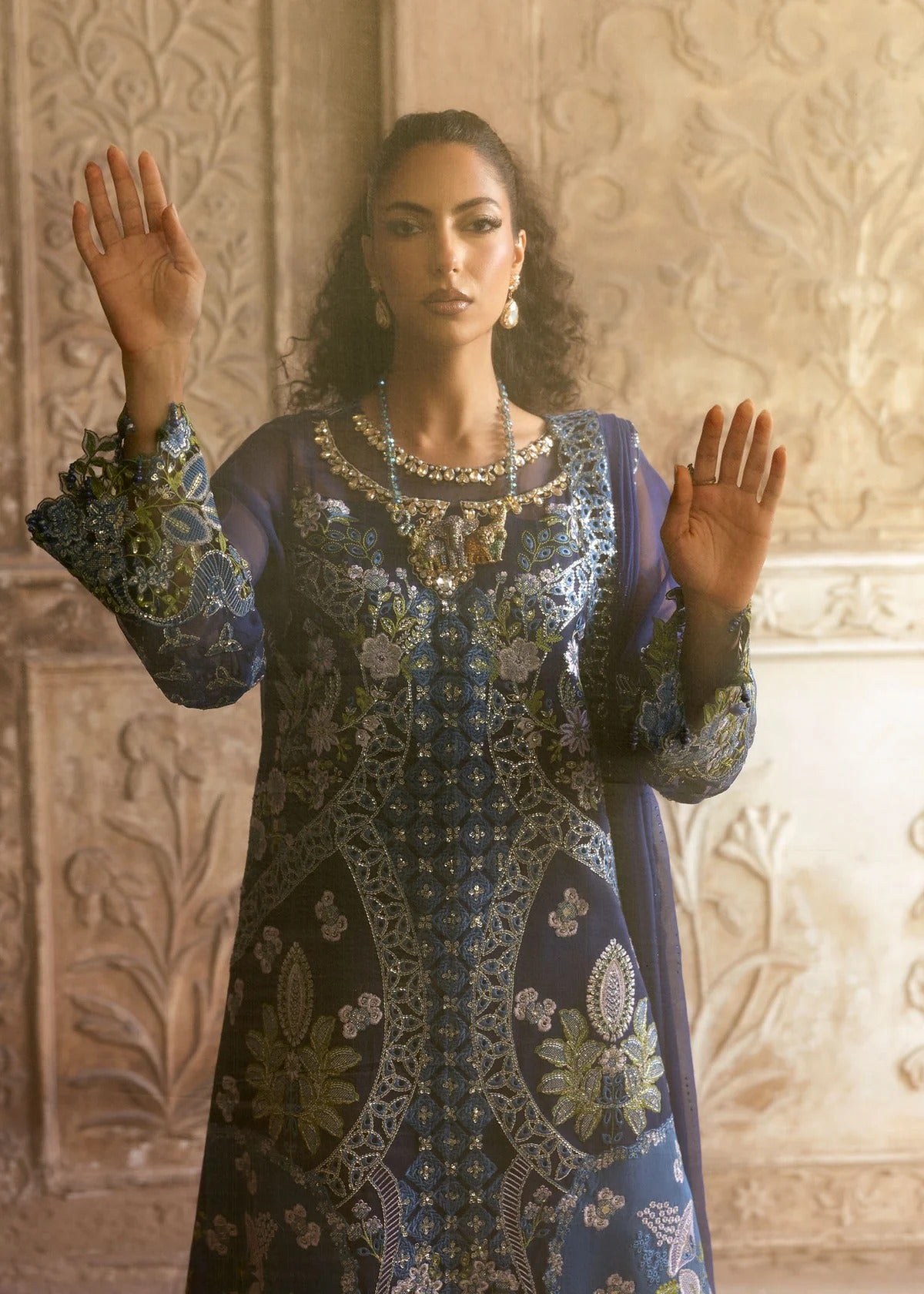 Stunning chiffon embroidered suit with hand-embellished neckline, cutwork motifs, diamante dupatta, and printed raw silk trouser for festive elegance.