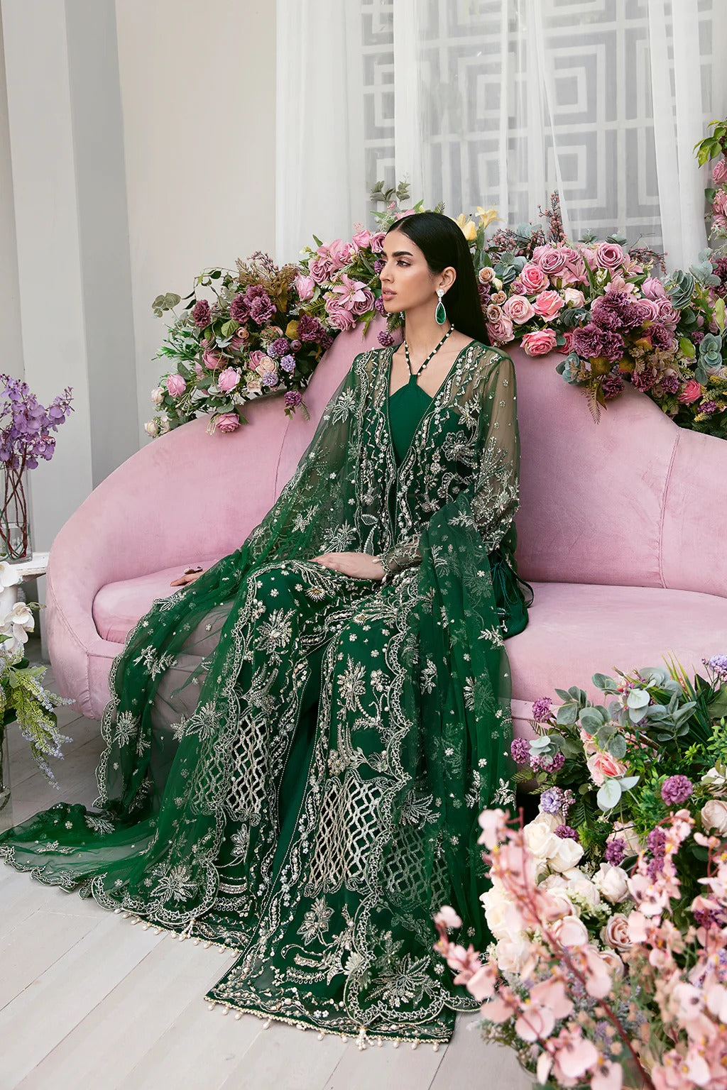 Luxury poly net embroidered suit with hand-embellished panels, cutwork sleeves, organza borders, embroidered dupatta, and raw silk trouser fabric.