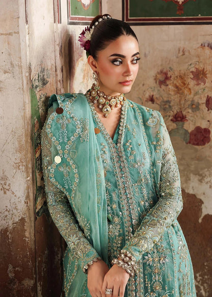 Discover timeless elegance with this turquoise organza outfit featuring intricate hand embroidery, foil-printed raw silk trouser, and embroidered dupatta.
