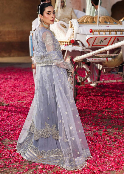 Grace your occasions with this periwinkle organza ensemble featuring hand-embroidered panels, borders, and dupatta, paired with a raw silk trouser for elegance.
