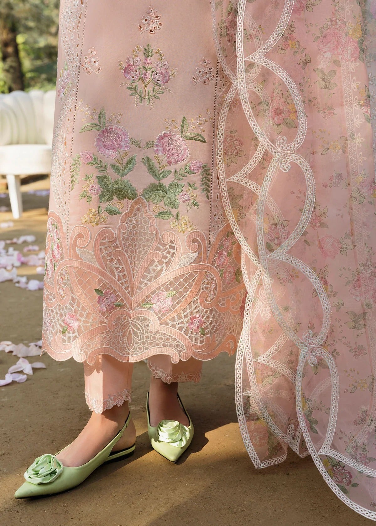 Grace your look with this peach embroidered lawn suit featuring chikan-kari panels, hand-work neckline, net dupatta, and cotton trouser.