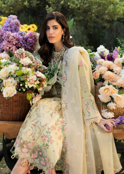 Shop this yellow embroidered lawn suit with chikan-kari sleeves, organza borders, woven net dupatta, and cotton trouser for an elegant summer look.