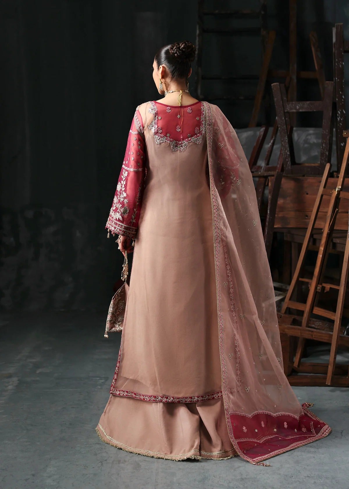 Chic rose pink organza suit with applique panels, cutwork neckline, embroidered dupatta, raw silk trouser, and elegant borders for a timeless festive look.