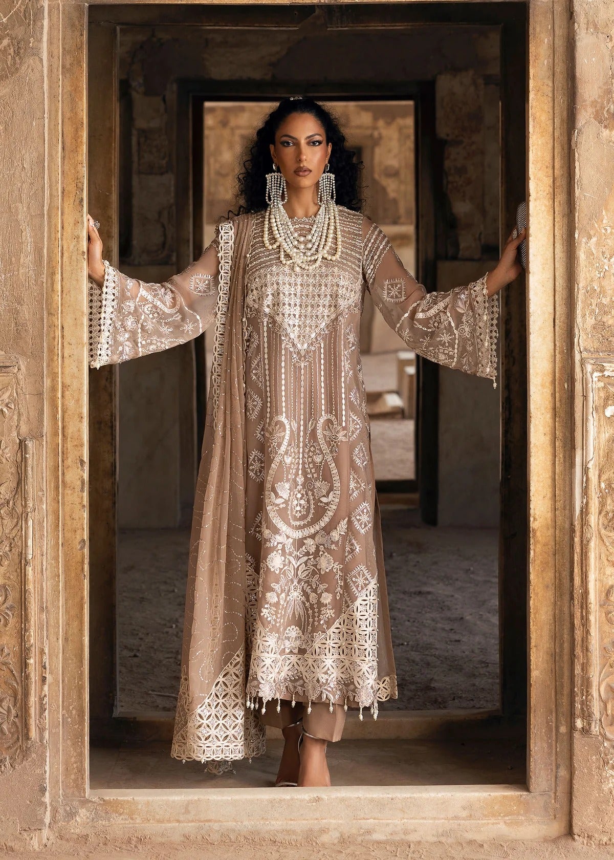 Exquisite chiffon suit with luxury hand embellishment, cutwork organza borders, embroidered dupatta, and raw silk trouser — ideal for weddings & parties.