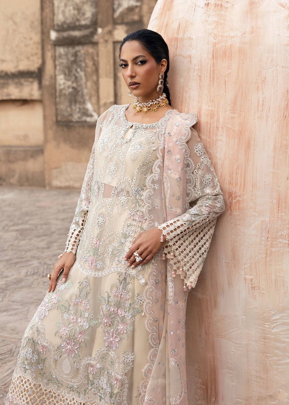 Elegant chiffon embroidered suit with hand embellishment, cutwork borders, diamante & mukesh dupatta, and raw silk trouser perfect for festive wear.