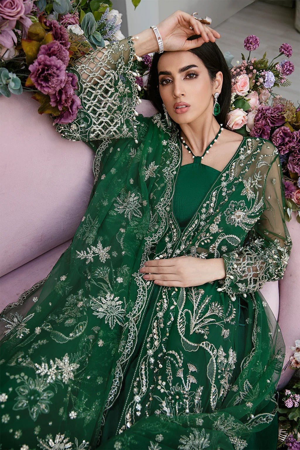Luxury poly net embroidered suit with hand-embellished panels, cutwork sleeves, organza borders, embroidered dupatta, and raw silk trouser fabric.