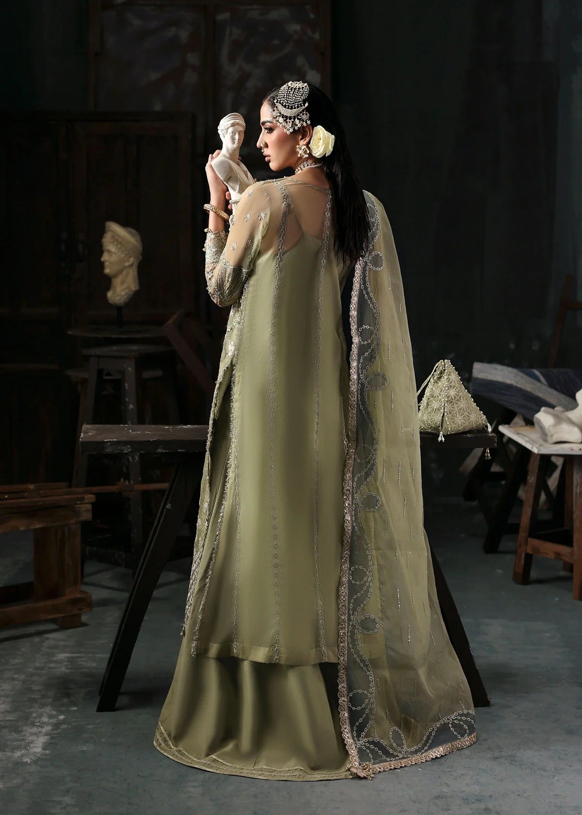Graceful olive green organza suit with dori work, cutwork neckline, embroidered dupatta, and raw silk trouser a perfect choice for festive elegance.