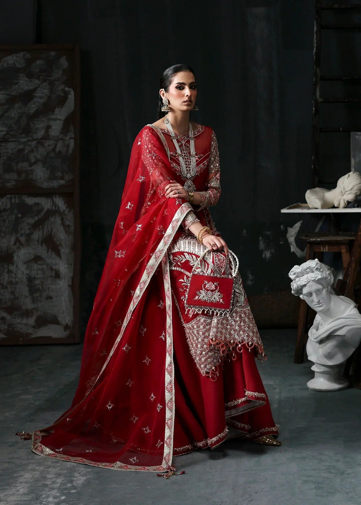 Stunning red organza dress with cutwork neckline, embroidered panels, dupatta & raw silk trouser. Available stitched/unstitch with custom sizing.