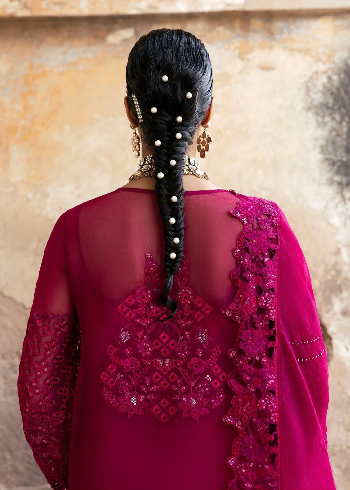 Elegant chiffon suit with hand-embellished neckline, cutwork borders, diamante dupatta with organza motifs, and raw silk trouser — ideal for festive wear.