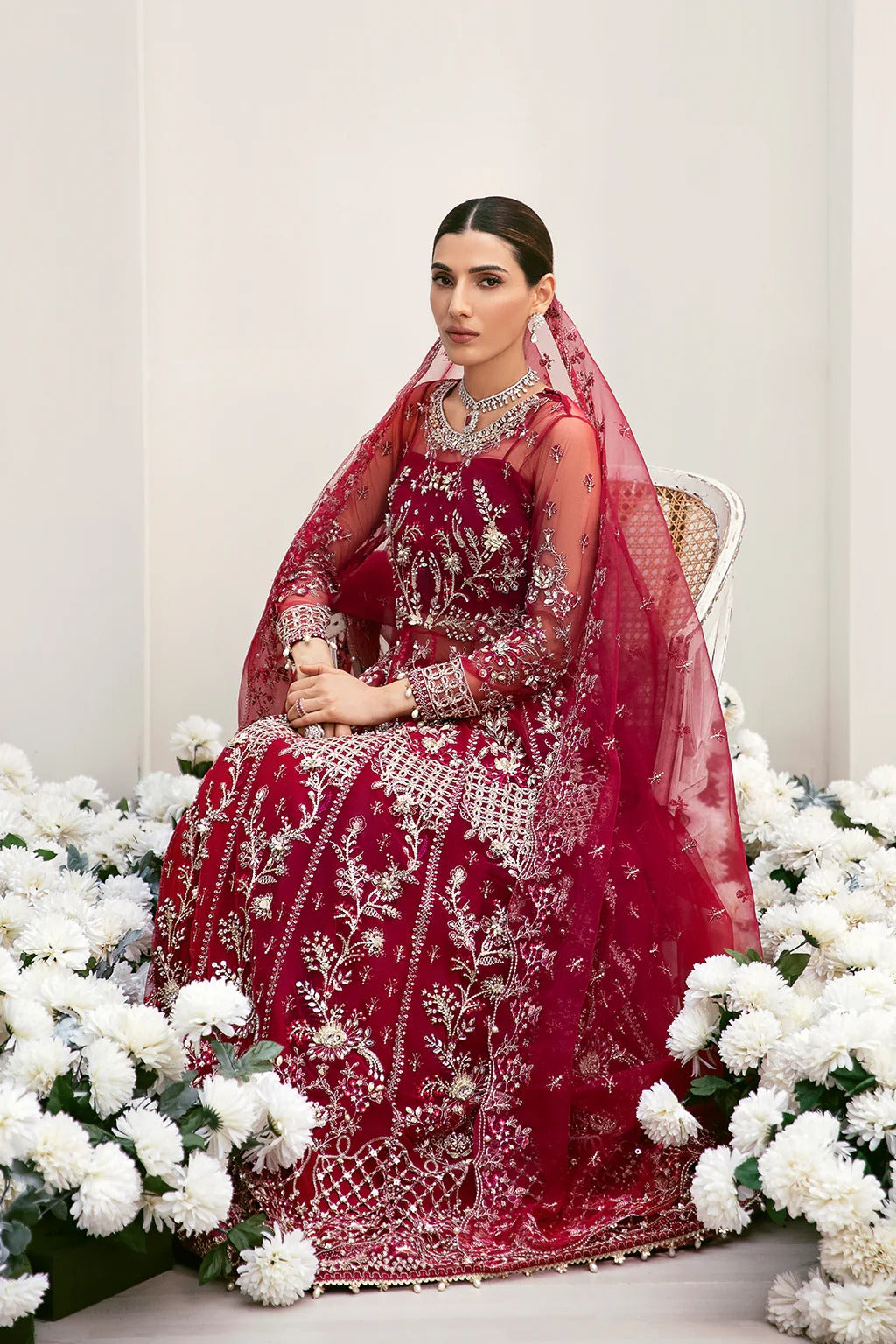 Graceful organza and poly net embroidered suit featuring hand-embellished bodice, cutwork panels, organza borders, dupatta, and raw silk trouser fabric.