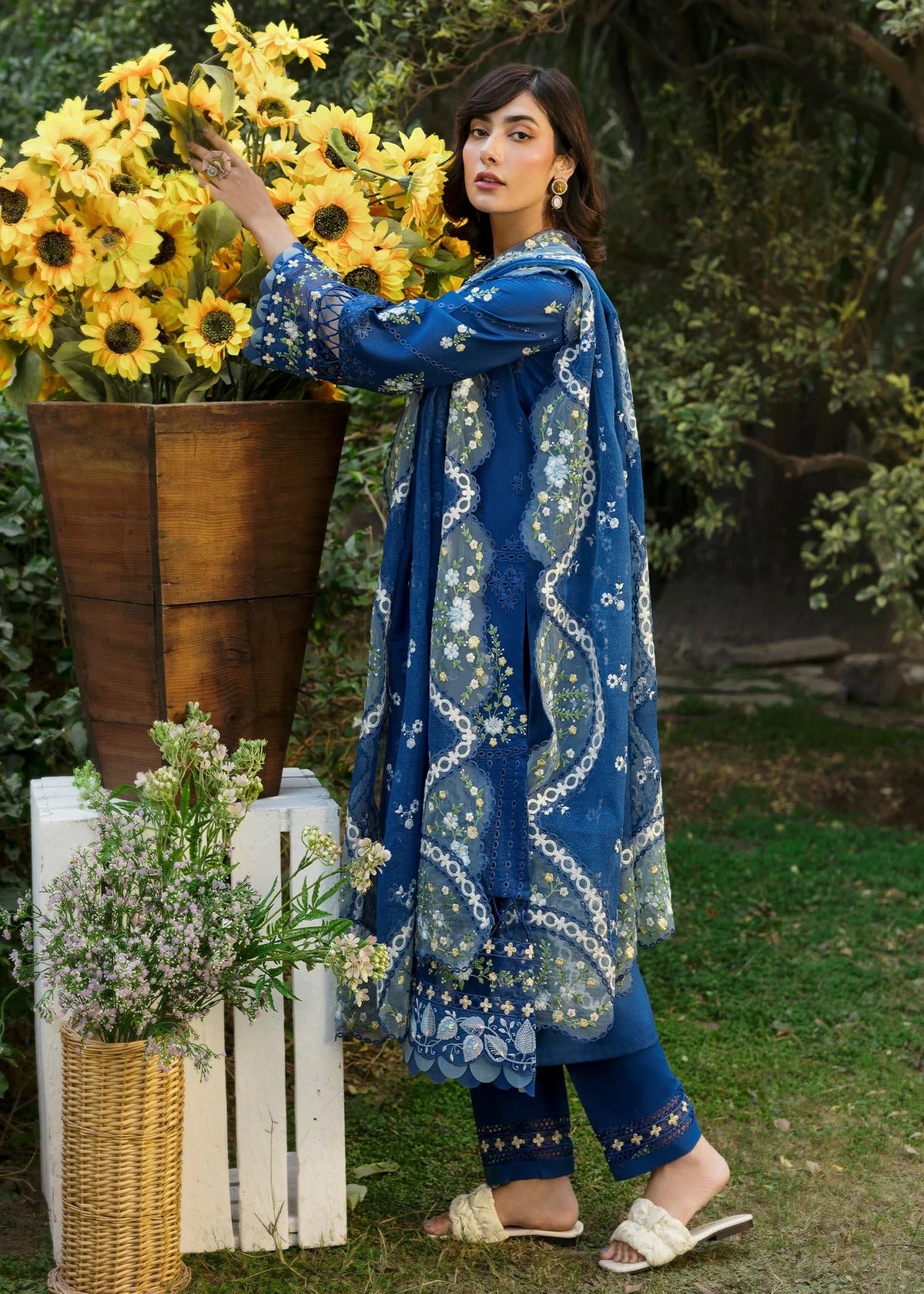 Step into elegance with this blue embroidered lawn suit featuring chikan-kari panels, hand-work neckline, net dupatta, and cotton trouser.