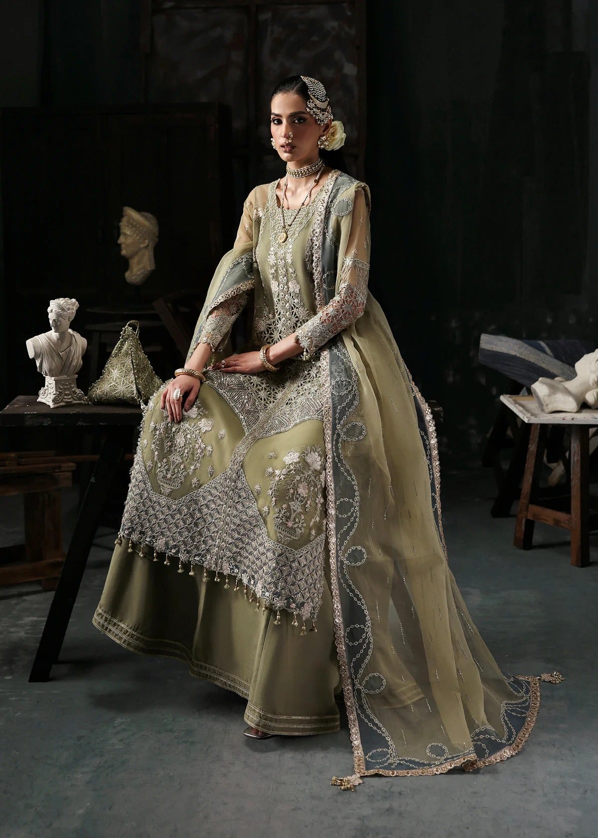 Graceful olive green organza suit with dori work, cutwork neckline, embroidered dupatta, and raw silk trouser a perfect choice for festive elegance.