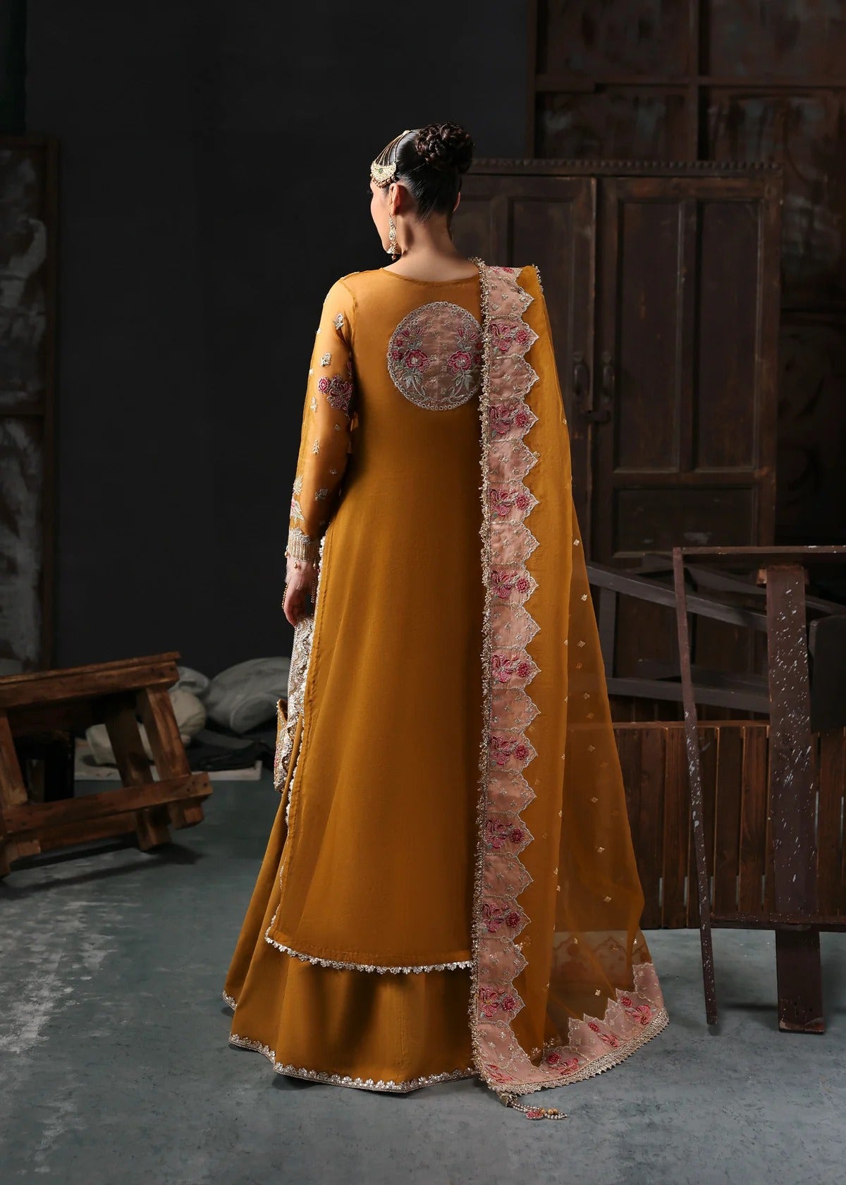 Chic mustard organza suit with applique front, embroidered neckline, dupatta with 4-side border, and raw silk trouser — perfect for festive wear.